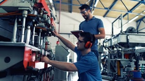 Maintenance technician inspecting industrial equipment for early failure indicators.