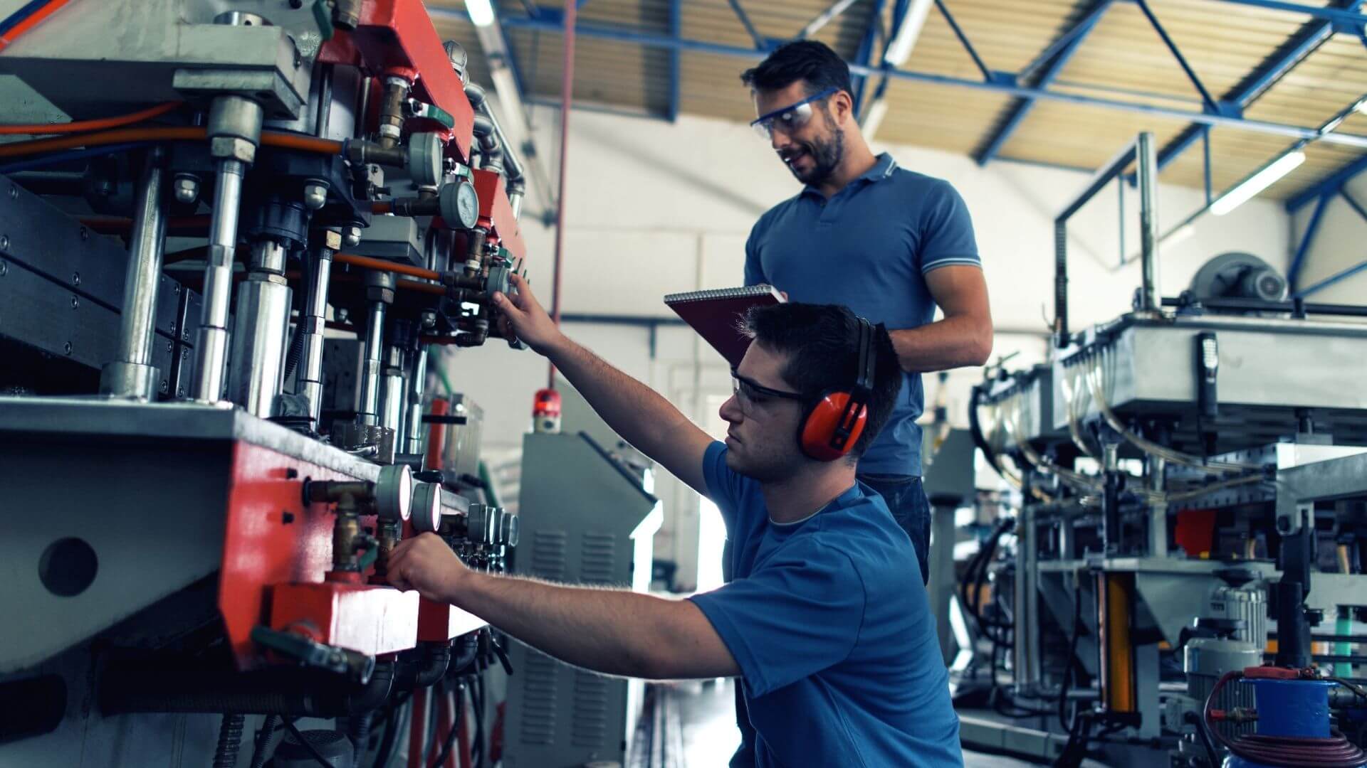 Maintenance technician inspecting industrial equipment for early failure indicators.